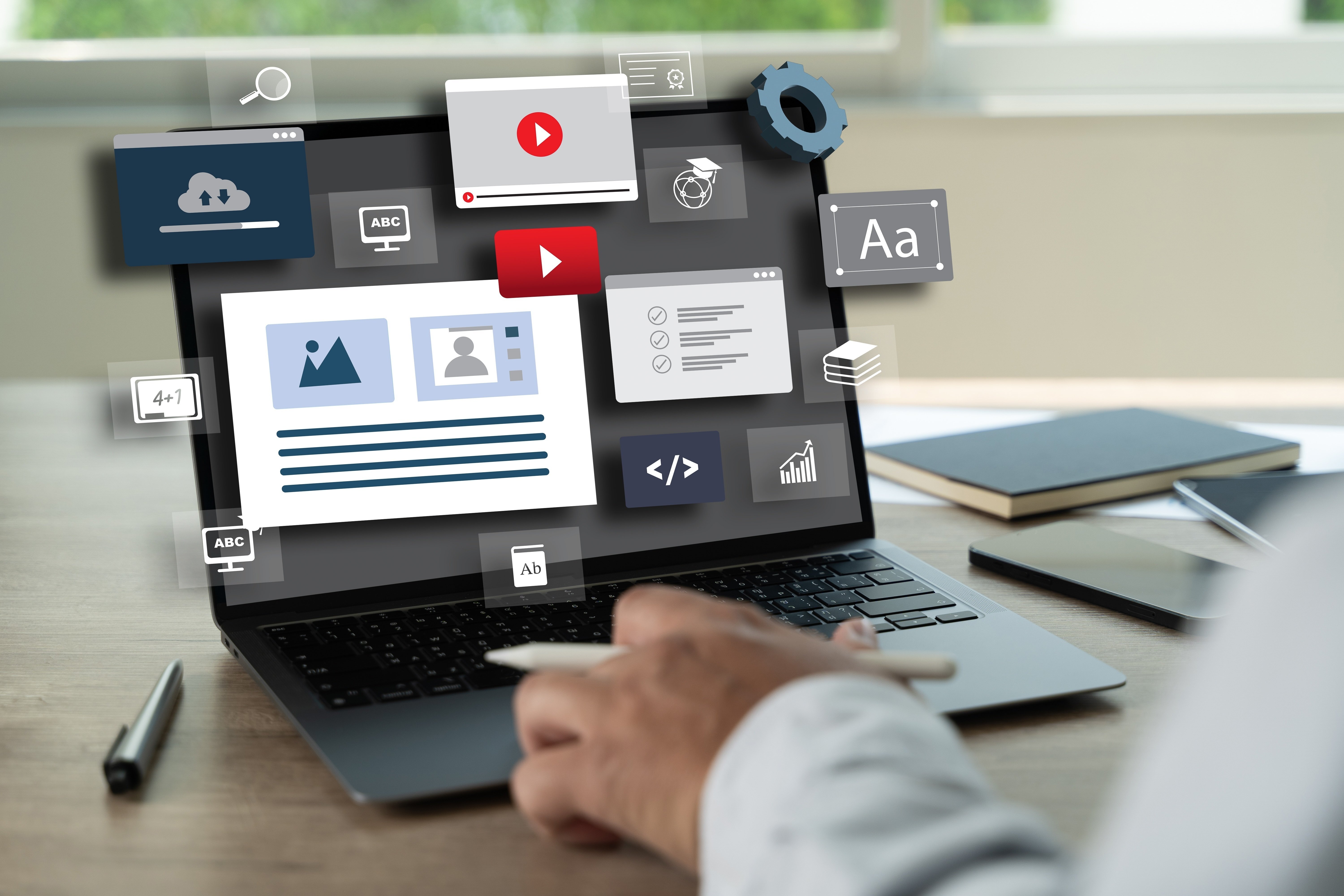Website design and development on laptop with digital content creation icons for SEO, coding, and user interface.